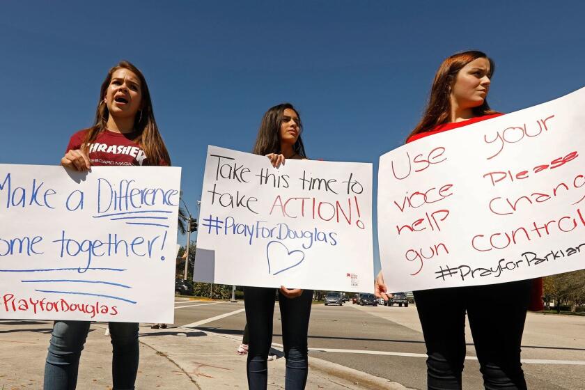 PARKLAND, FLORIDA--FEB. 16, 2018--People protest on a corner not far from Marjorie Stonemason Douglas High School in Parkland, Florida where a gunman killed 17 dead and injured 14 in a school shooting. They are calling for action on gun control. (Carolyn Cole/Los Angeles Times)