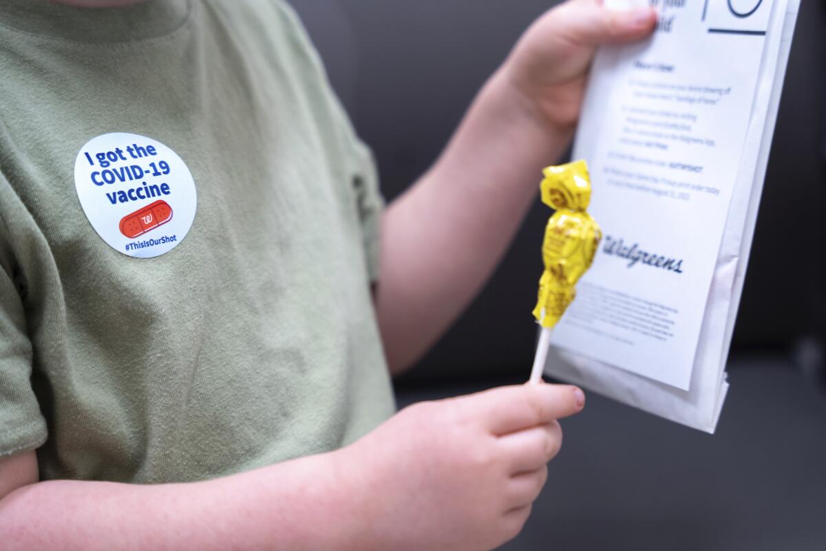 A 3-year-old holds a lollipop after getting vaccinated against COVID-19 in Lexington, S.C., on June 20. 