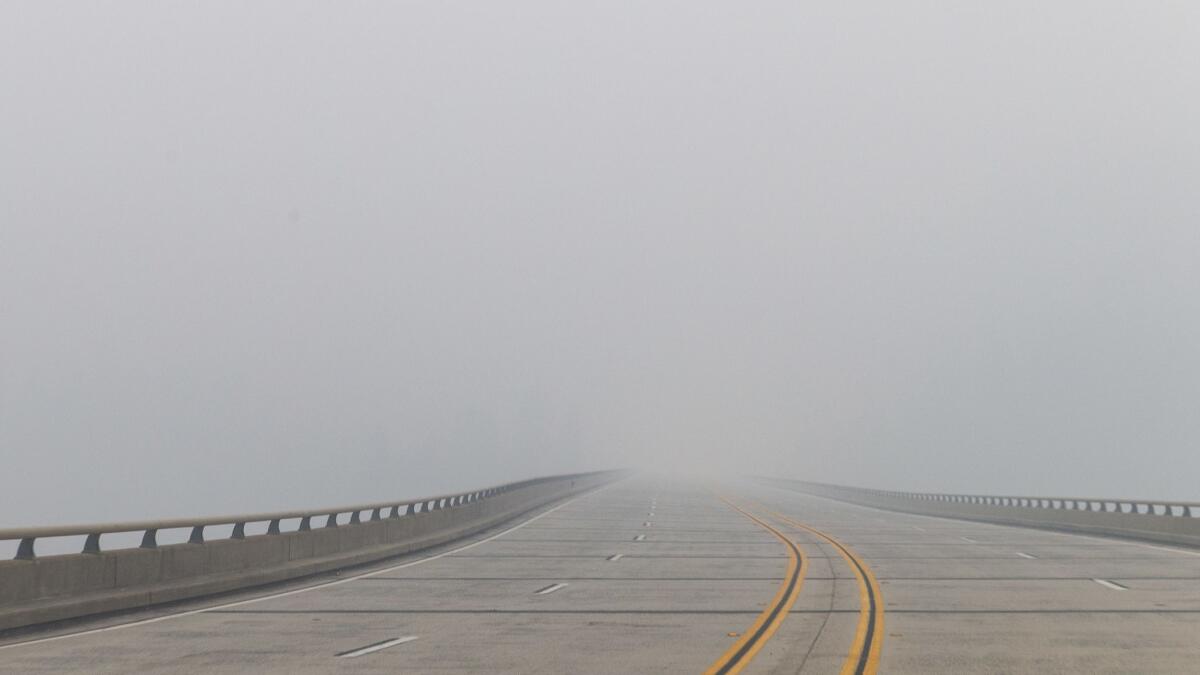 Smoke from the Camp fire obscures the view of Highway 70 near Concow.