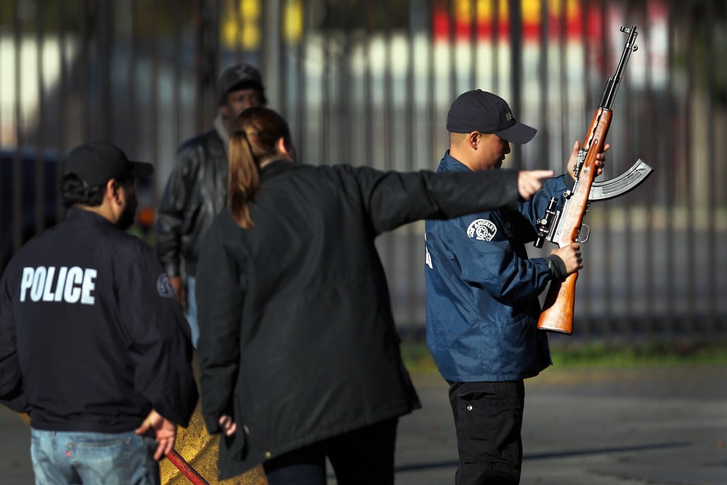An officer inspects a weapon turned in during the gun buyback.