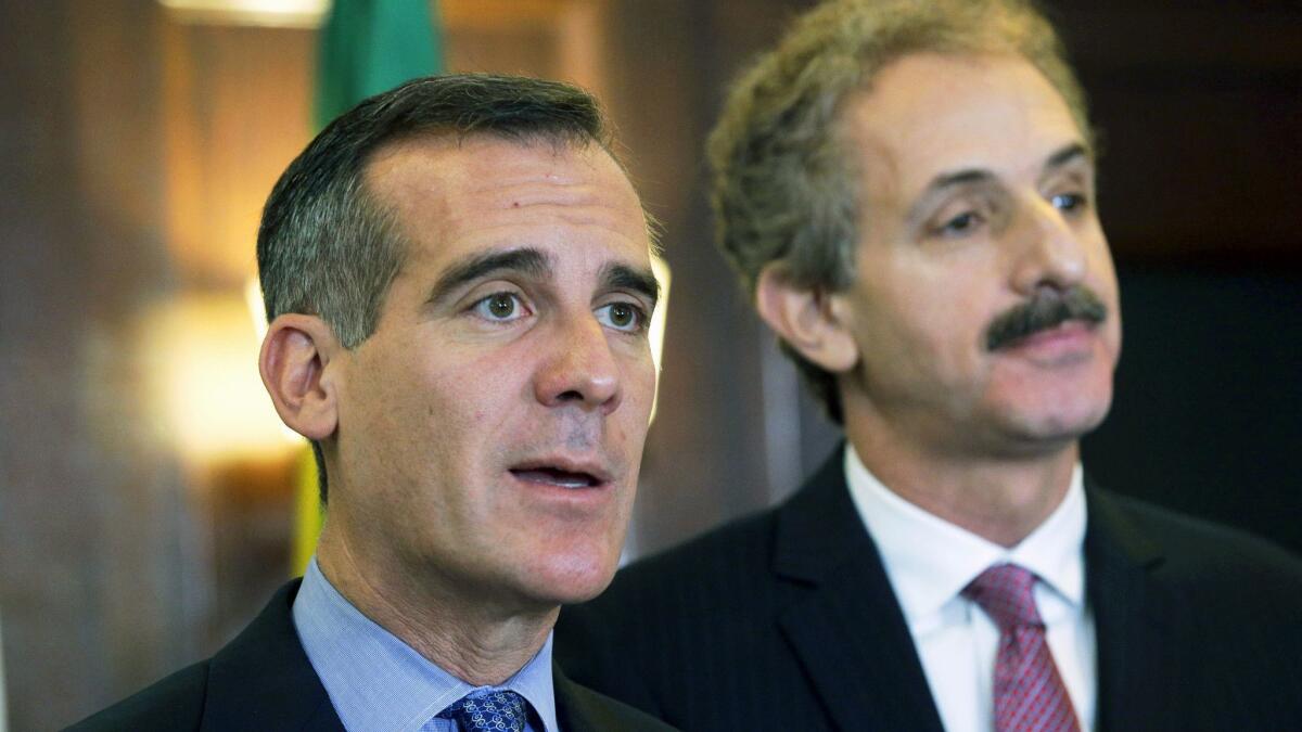 Los Angeles Mayor Eric Garcetti, left, and City Atty. Mike Feuer attend a City Hall news conference in 2016.