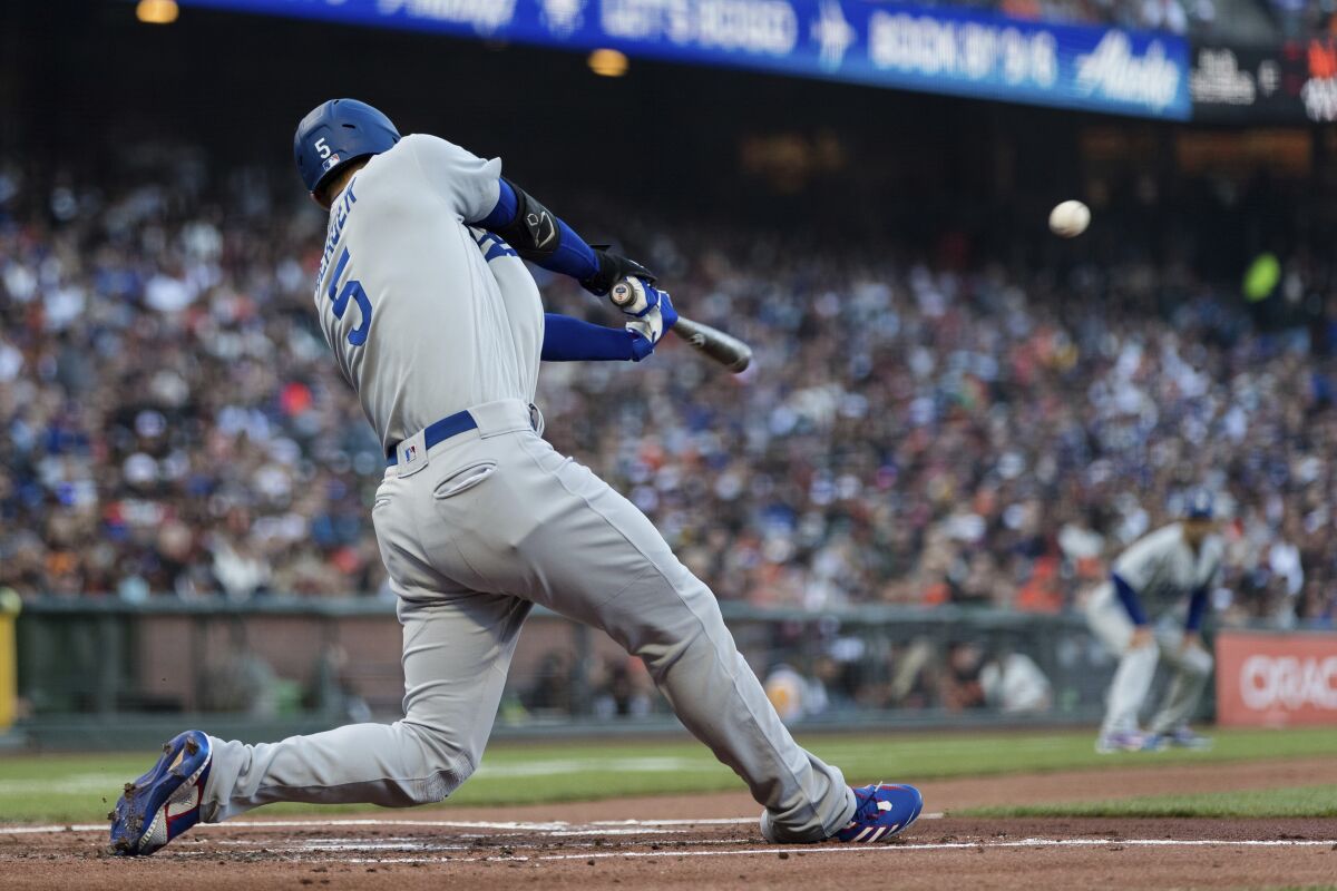 Dodgers shortstop Corey Seager hits a sacrifice fly against the Giants in the first inning.