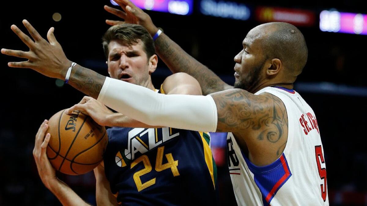 Utah center Jeff Withey battles with Clippers forward Marreese Speights after grabbing a rebound during an Oct. 10 preseason game.