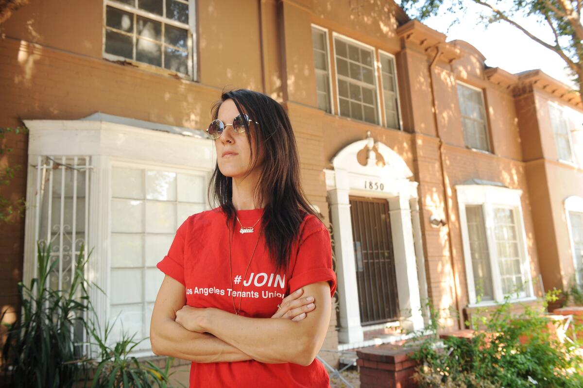Tenant-activist Sylvie Shain stands in front of a Cherokee Avenue apartment building that is being converted into a hotel.