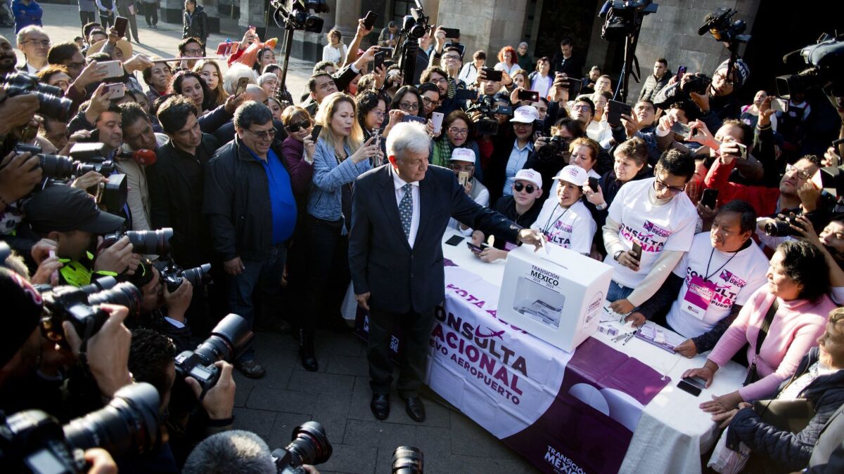 Mexico's President-elect Andres Manuel Lopez Obrador casts his vote on whether to continue with a $13-billion airport. After residents voted against the airport, Lopez Obrador said he'll cancel the partially built airport.