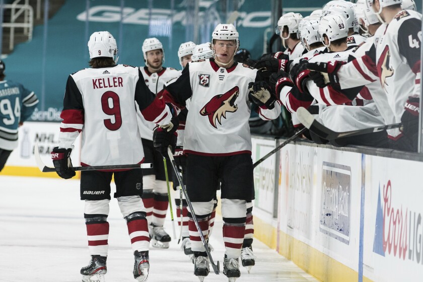 Arizona Coyotes center Christian Dvorak (18) is congratulated for his goal against the San Jose Sharks during the first period of an NHL hockey game in San Jose, Calif., Saturday, May 8, 2021. (AP Photo/John Hefti)
