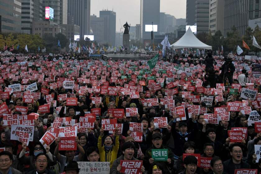 Demonstrators hold placards calling for the resignation of South Korean President Park Geun-Hye on Nov. 5 in central Seoul.