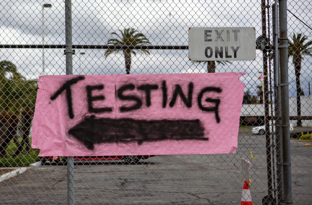 A sign directs drivers to drive-through coronavirus testing at Crenshaw Christian Center on Sunday in South Los Angeles.