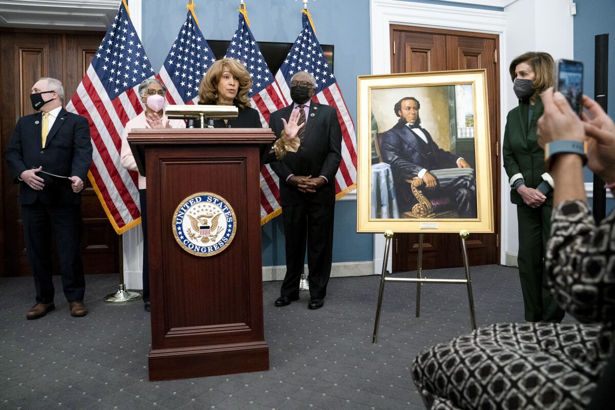Joseph H. Rainey's great-granddaughter Lorna Rainey addresses reporters during a news conference to unveil the Joseph H. Rainey Room at the U.S. Capitol in Washington, Thursday, Feb. 3, 2022. Joseph H. Rainey was born into slavery in 1832. He was elected to Congress representing South Carolina and sworn into office in 1870, becoming the first Black member of the House. From left, House Minority Whip Rep. Steve Scalise, R.La., Rep. Joyce Beatty, D-Ohio, Lorna Rainey, House Majority Whip James Clyburn, D-S.C., and House Speaker Nancy Pelosi of Calif. (Greg Nash/Pool via AP)