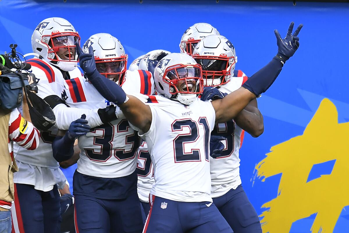 New England Patriots safety Adrian Phillips celebrates after scoring off an interception return.