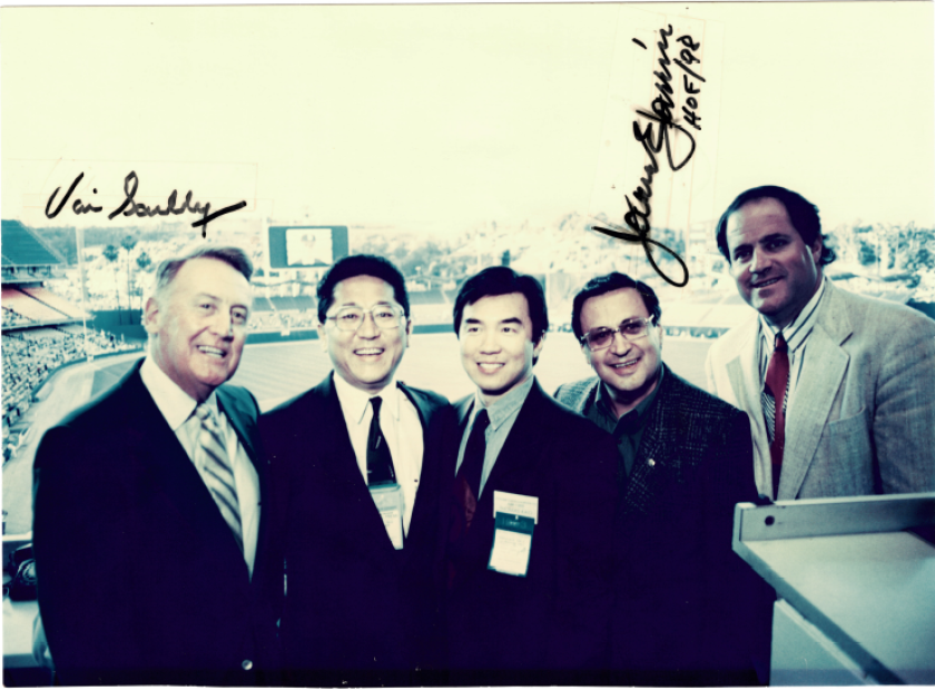 Richard Choi stands with Vin Scully, left, in a press box of the Dodger Stadium.