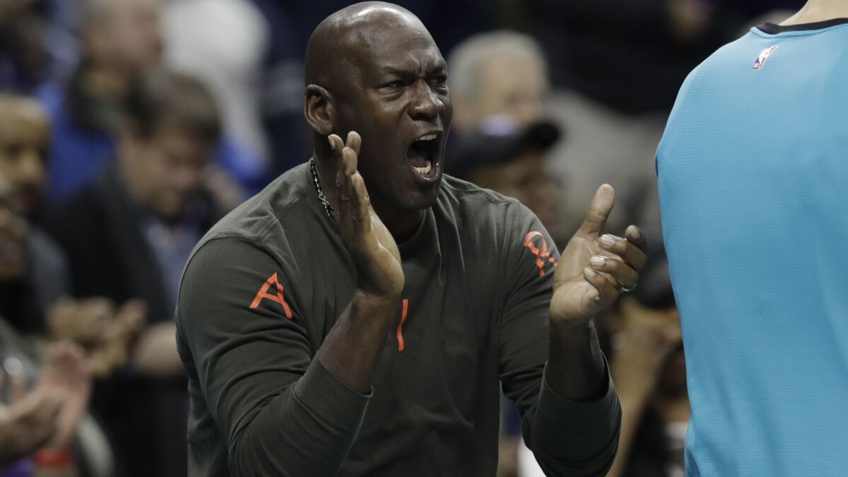 Charlotte Hornets owner Michael Jordan, reacting to a play by the team against the Detroit Pistons in a recent game, inspired LeBron James from an early age.
