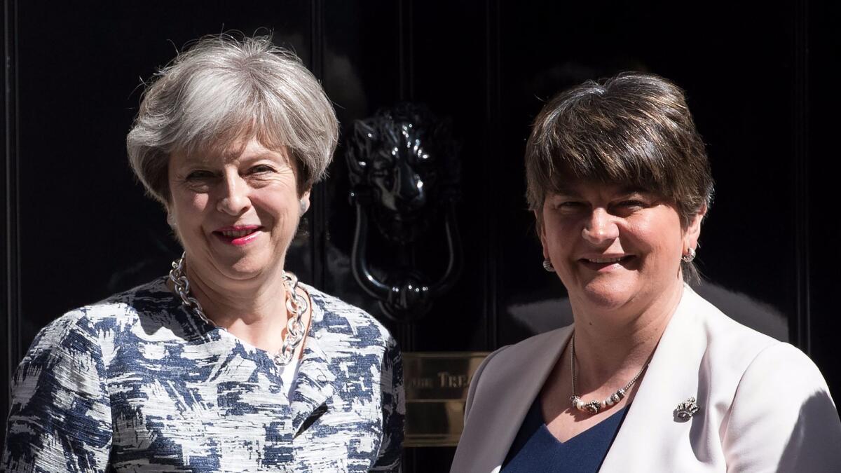 Britain's Prime Minister, Theresa May, left, greets Arlene Foster, the leader of Northern Ireland's Democratic Unionist Party, in Downing Street on June 26, 2017 in London.