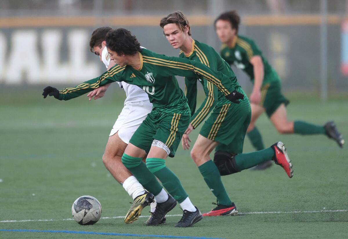 Edison's Rafael Godoi (10) tries to make a takeaway on defense against Newport Harbor on Monday.