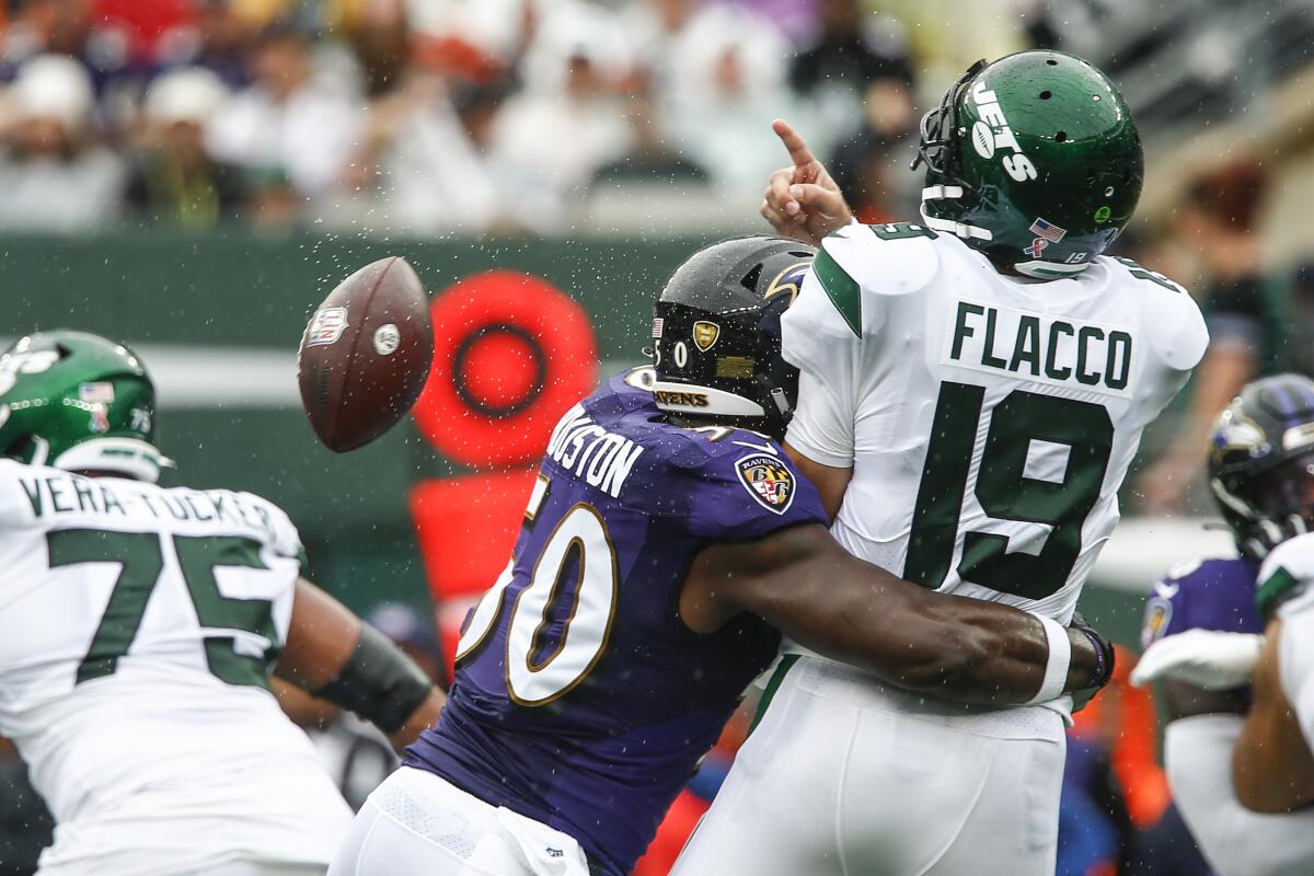 Baltimore Ravens' Justin Houston (50) hits New York Jets quarterback Joe Flacco (19) as he throws a pass during the first half of an NFL football game Sunday, Sept. 11, 2022, in East Rutherford, N.J. (AP Photo/John Munson)