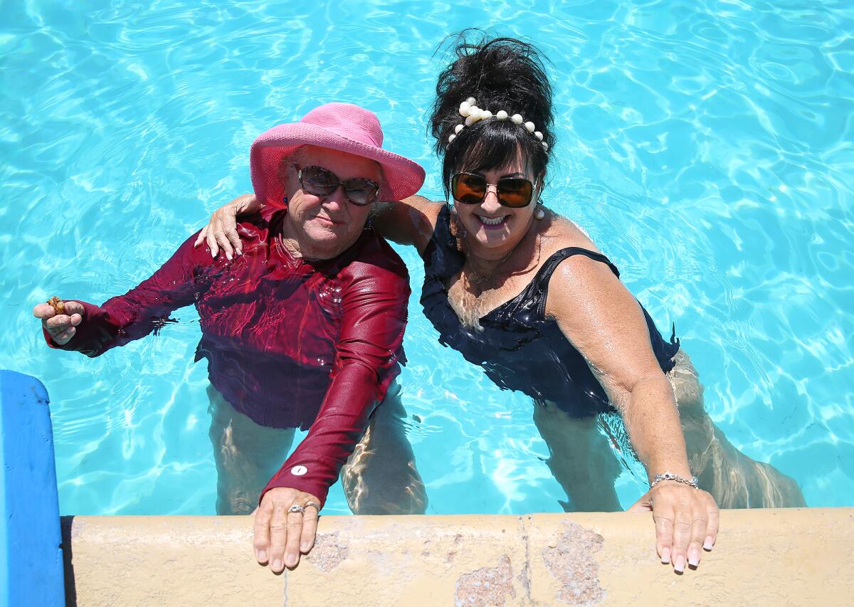 Mermaids Linda Lobdell and Lori Diamond take a break from a Mermaid-a-Thon.