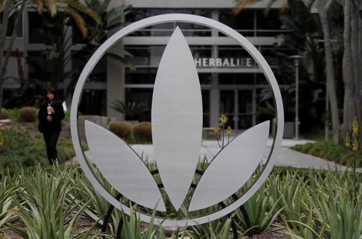 The Herbalife logo is mounted in a garden of aloe plants at company headquarters in Torrance.