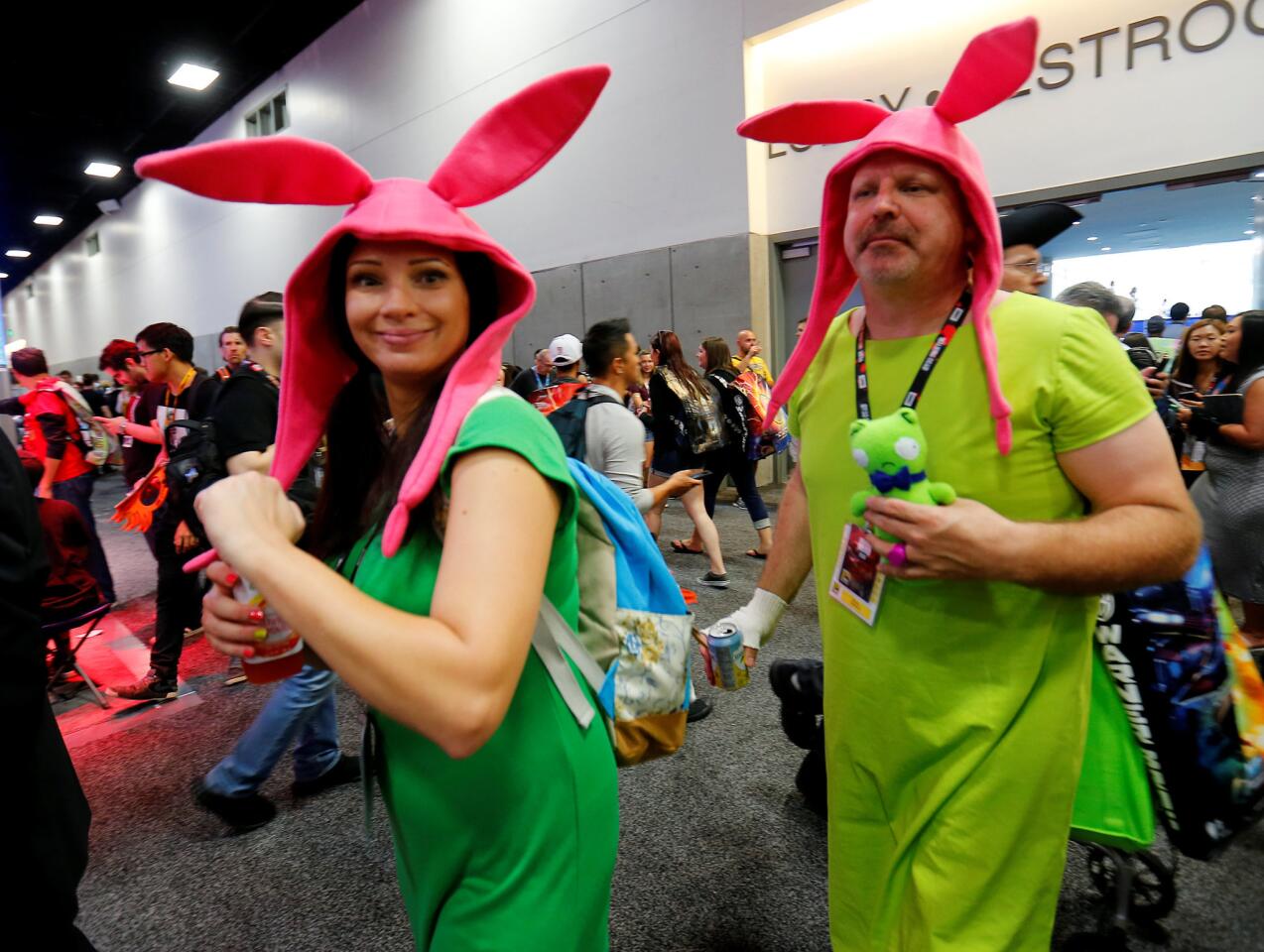 Attendees in costume walk the convention floor during opening day of Comic-Con International in San Diego, California,