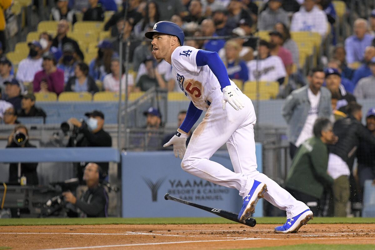 Dodgers first baseman Freddie Freeman drops his bat after hitting a home run against the Atlanta Braves.