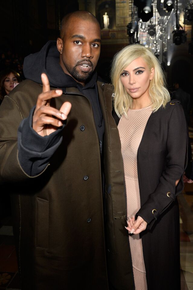 Kanye West and Kim Kardashian, friends of designer Alber Elbaz, attend the Lanvin show during Paris Fashion Week Fall/Winter 2015/2016 on March 5, 2015, in Paris.