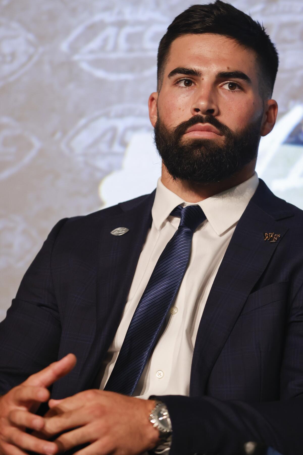 Wake Forest quarterback Sam Hartman sits on the stage at the NCAA college football Atlantic Coast Conference Media Days in Charlotte, N.C., Wednesday, July 20, 2022. (AP Photo/Nell Redmond)