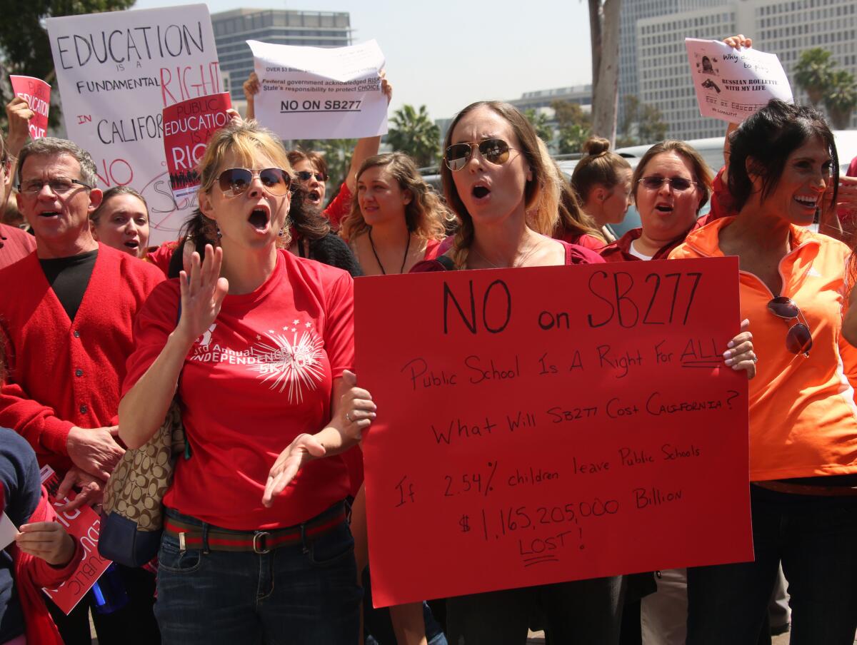 Parents and teachers who oppose efforts to end the personal belief exemption on vaccinations rally outside Los Angeles Unified School District headquarters on April 14.