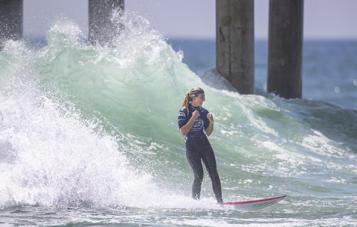 Sage Erickson celebrates after making a big carving turn off the top of a wave in the U.S. Open of Surfing women's final in Huntington Beach on Sunday.