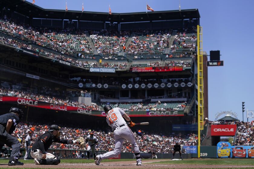 Baltimore Orioles' Josh Lester (49) hits a two-run single in front of San Francisco Giants catcher Patrick Bailey, second from left, during the third inning of a baseball game in San Francisco, Sunday, June 4, 2023. Orioles' Ryan Mountcastle also scored on the play after a throwing error by Giants center fielder Austin Slater. (AP Photo/Jeff Chiu)