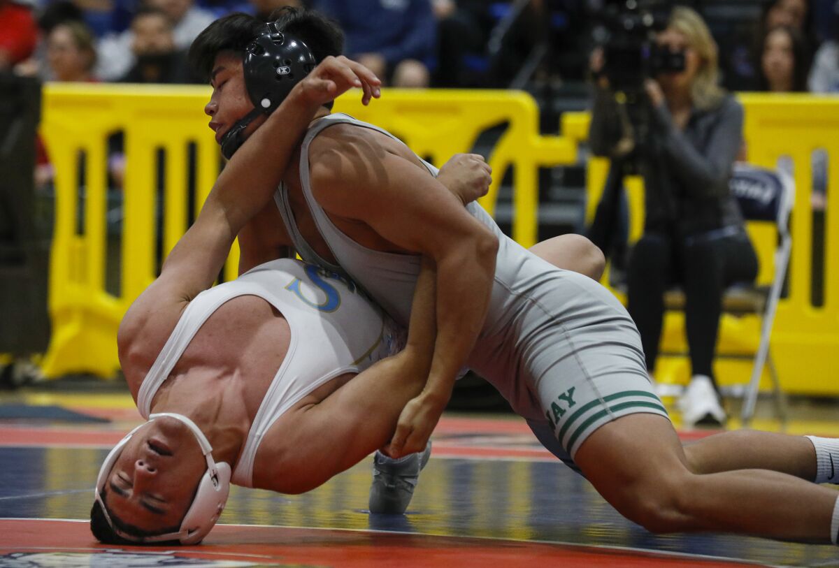 Poway's Noah Tolentino (top) gets the better of San Ysidro's Santiago Luna as Tolentino wins the 145 weight class.