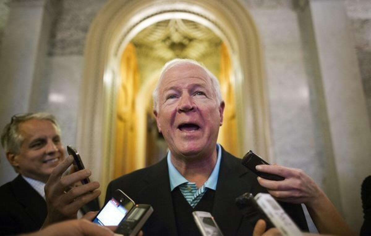 Sen. Saxby Chambliss (R-Ga.) tells reporters about the hole in one he made during a golf outing earlier in the day with President Obama and two other senators.