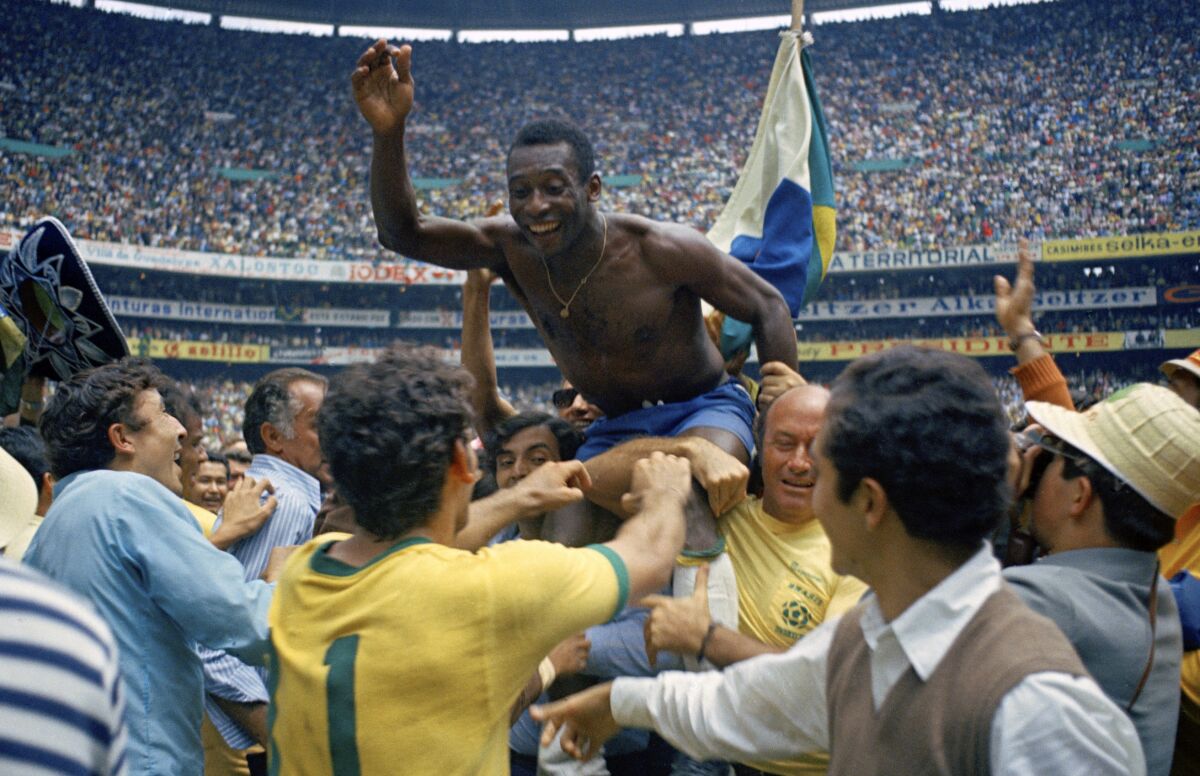 Pelé is carried off the field by his teammates after Brazil's 1970 World Cup victory.
