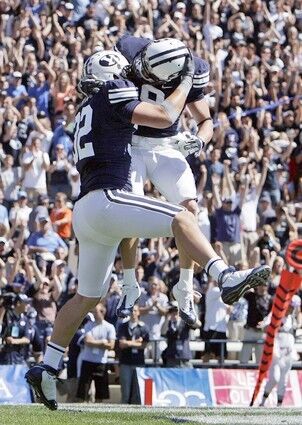 Brigham Young tight end Dennis Pitta, left, celebrates his touchdown against UCLA with teammate Austin Collie during the first quarter Saturday.