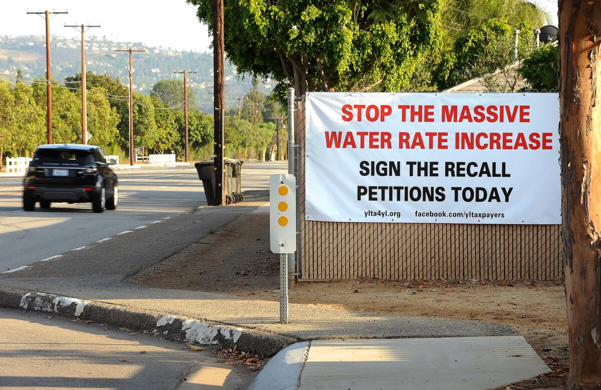 A sign calling for Yorba Linda residents to sign a petition to stop water rate increases is posted on a fence in Yorba Linda earlier this year.