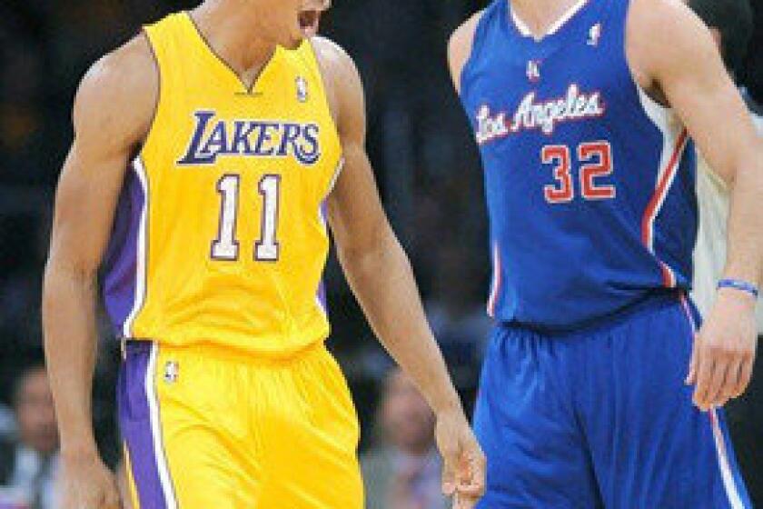 Wesley Johnson, left, celebrates in front of Blake Griffin after hitting a three-pointer during the Lakers' 116-103 season-opening victory over the Clippers.