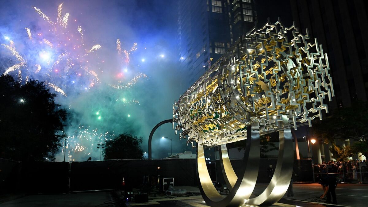 Fireworks go off behind the Freedom Sculpture in Century City on July 4, 2017.