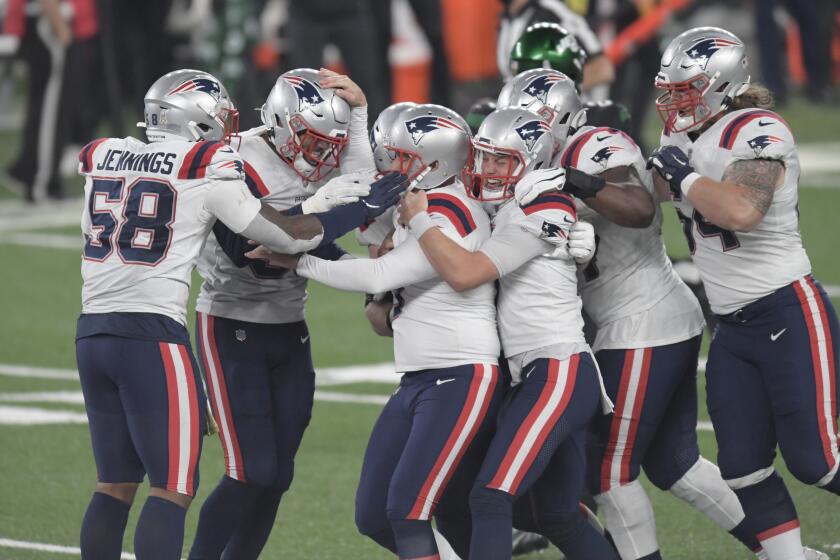 New England Patriots kicker Nick Folk, center, celebrates with teammates after kicking the winning field goal during the second half of an NFL football game against the New York Jets, Monday, Nov. 9, 2020, in East Rutherford, N.J. The Patriots defeated the Jets 30-27. (AP Photo/Bill Kostroun)