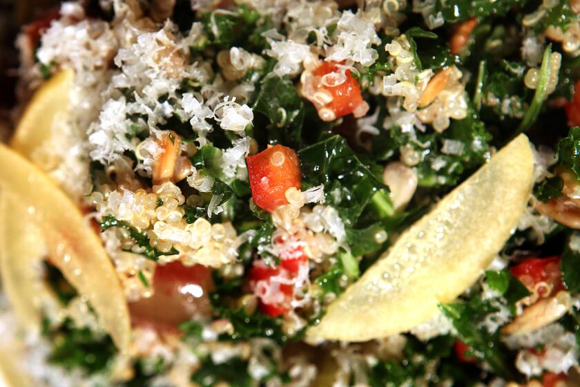 Dark green julienned strips of kale are tossed with nutty quinoa and sunflower seeds.