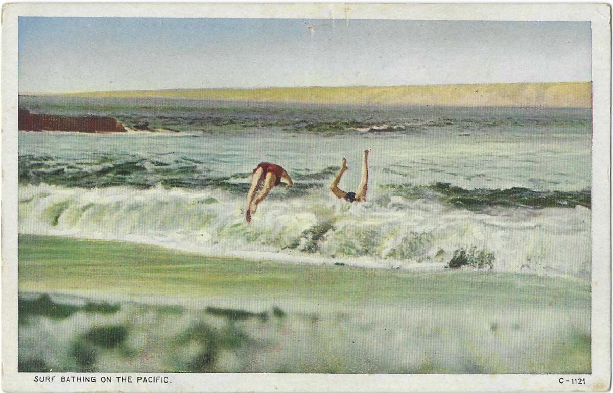 The legs of two swimmers are all that can be seen sticking out of the surf. "Surf bathing on the Pacific," the card reads.