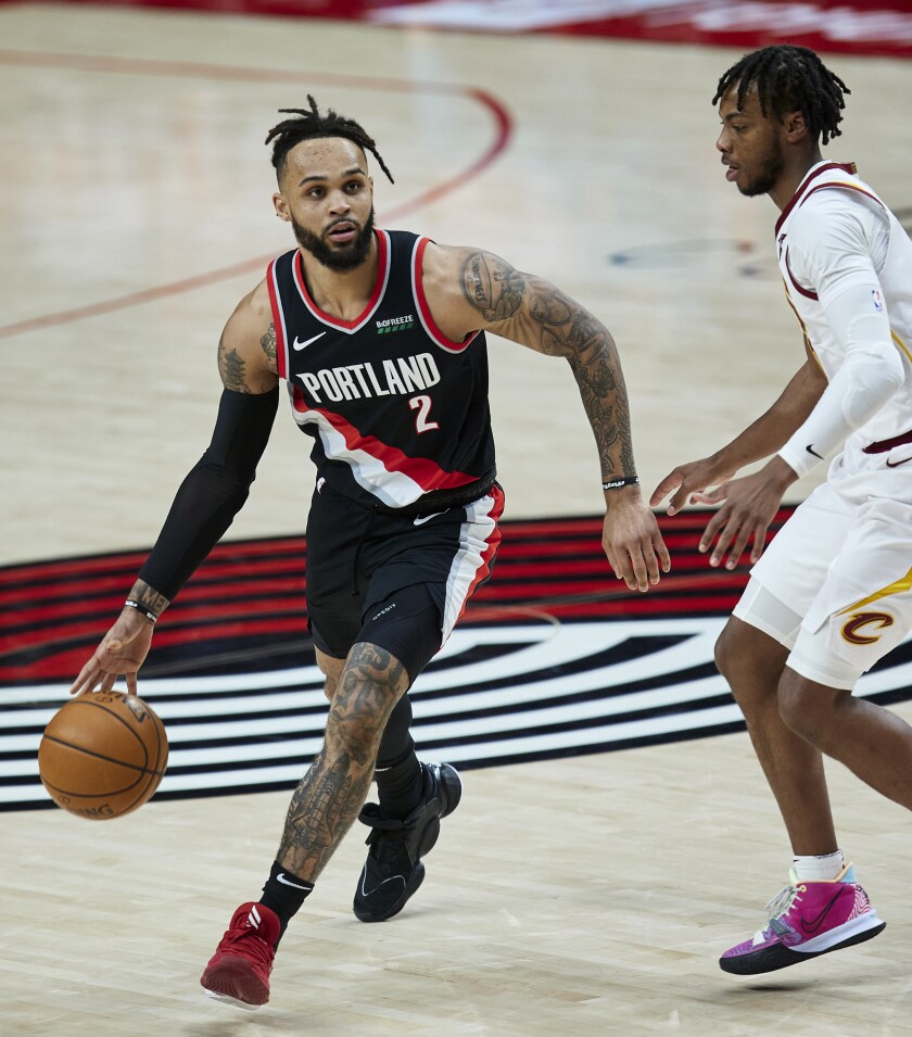 Portland Trail Blazers guard Gary Trent Jr., left, works around Cleveland Cavaliers guard Darius Garland during the second half of an NBA basketball game in Portland, Ore., Friday, Feb. 12, 2021. (AP Photo/Craig Mitchelldyer)
