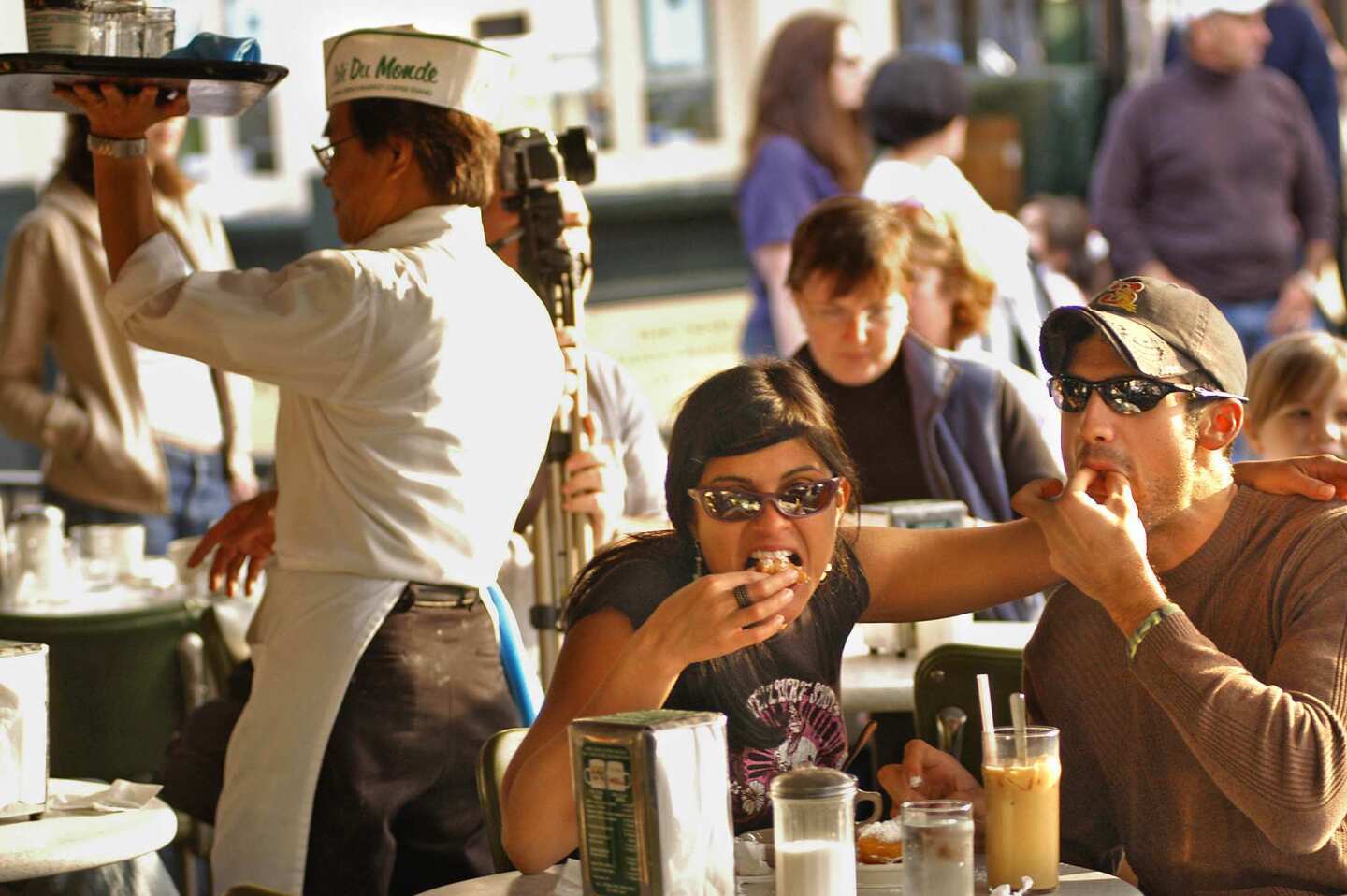 Christina Gomez and Bobby Heinz enjoy beignets at Cafe du Monde in the French Quarter.