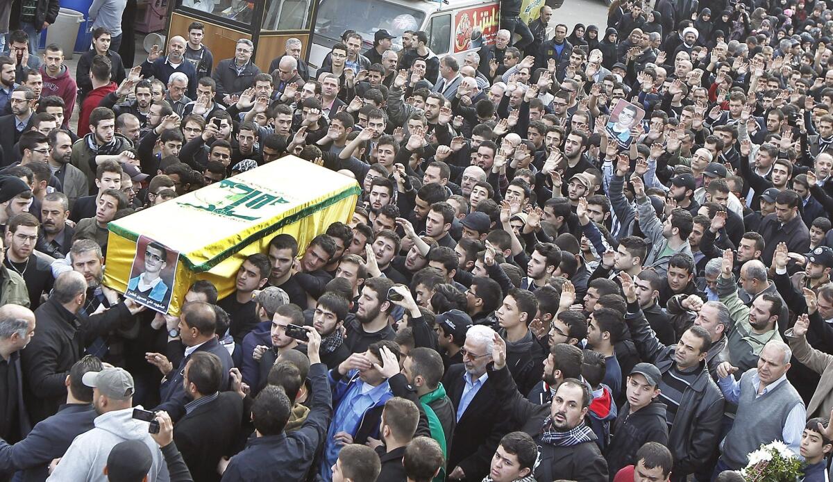 Relatives and friends of teenager Ali Khadra carry his coffin during a funeral procession in a suburb of Beirut on Saturday. Khadra was one of the victims of a car bombing last Thursday.