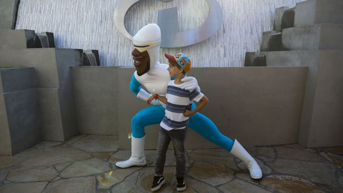Frozone from Pixar's "The Incredibles" poses for pictures with a guest.