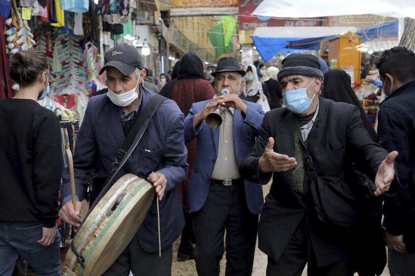 Performers play folklore music welcoming Persian New Year, or Nowruz, meaning "New Day." in northern Tajrish Square, Tehran, Iran, Wednesday, March 17, 2021. (AP Photo/Ebrahim Noroozi)