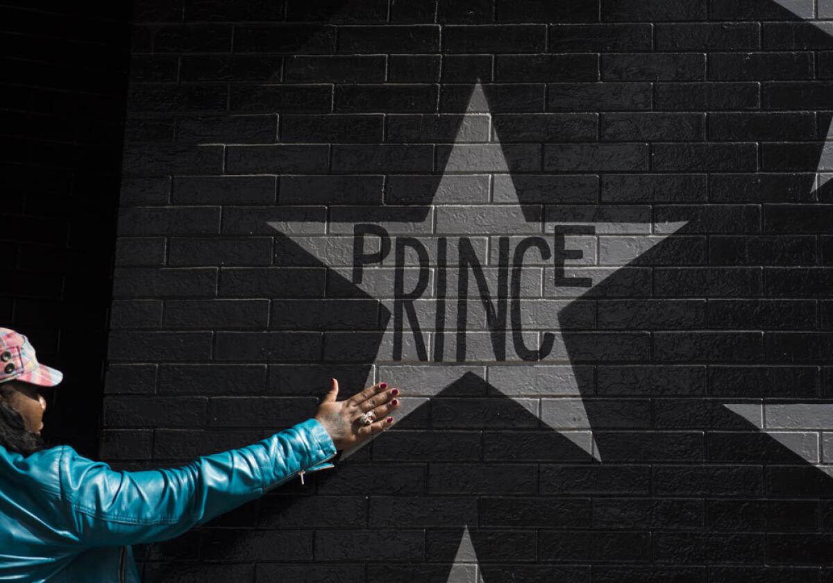 A woman touches thethe wall outside the First Avenue nightclub in Minneapolis.