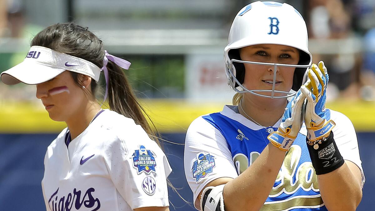 UCLA's Kylee Perez, right, reacts next to LSU's Amber Serrett after reaching second base on a bunt and throwing error in the first inning Thursday.