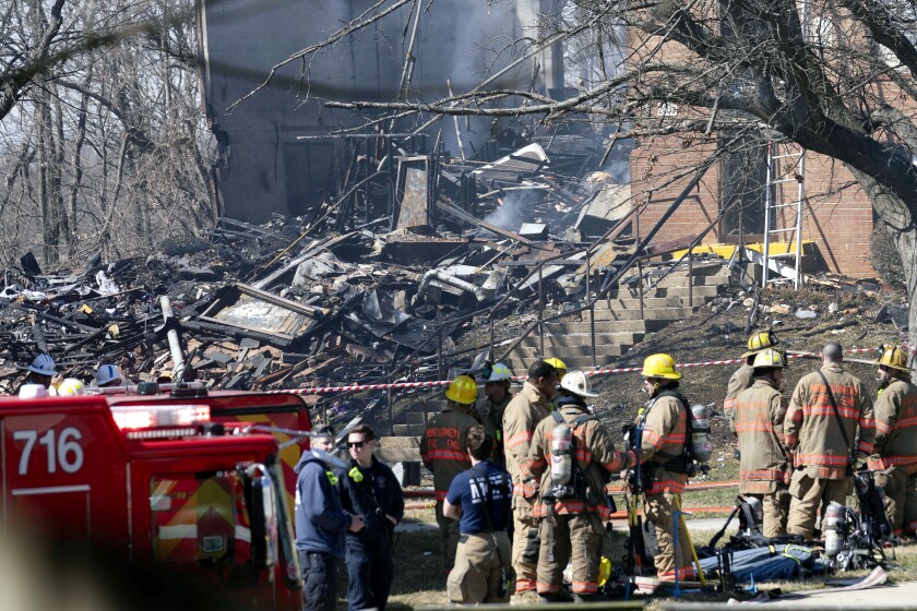 Charred rubble is seen after an apartment building collapsed after an explosion this morning in Silver Spring, Md., Thursday, March, 3, 2022. Montgomery County Fire and Rescue Service reports that multiple people were critically hurt in the fire that started at about 10:30 a.m. at a four-story building at the Friendly Garden Apartments in Silver Spring, Md. (AP Photo/Jose Luis Magana)