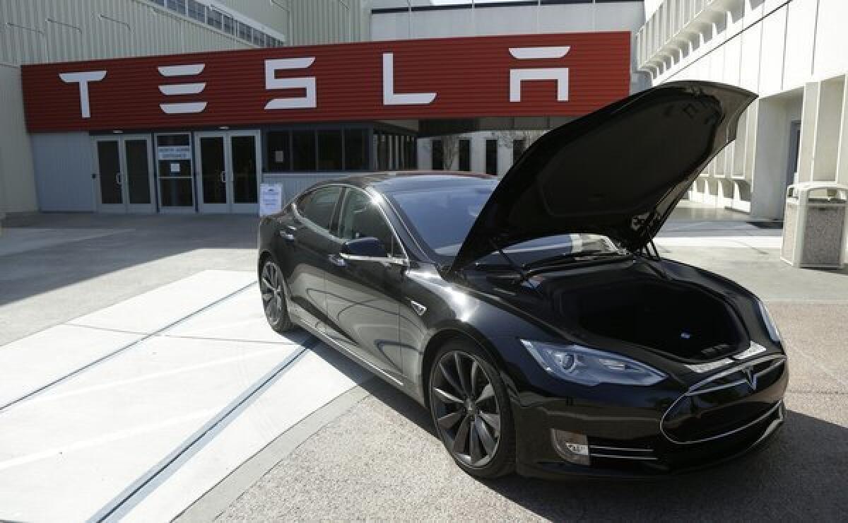 Tesla Motors used money from stock and debt offering deals to fully pay off a Department of Energy loan.