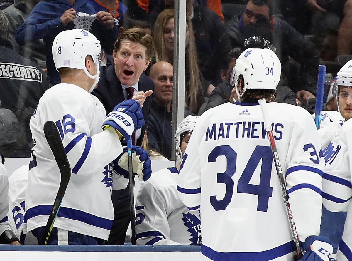 Maple Leafs coach Mike Babcock talks to Andreas Johnsson (18) and Auston Matthews (34) during a game against the New York Islanders on Nov. 13.