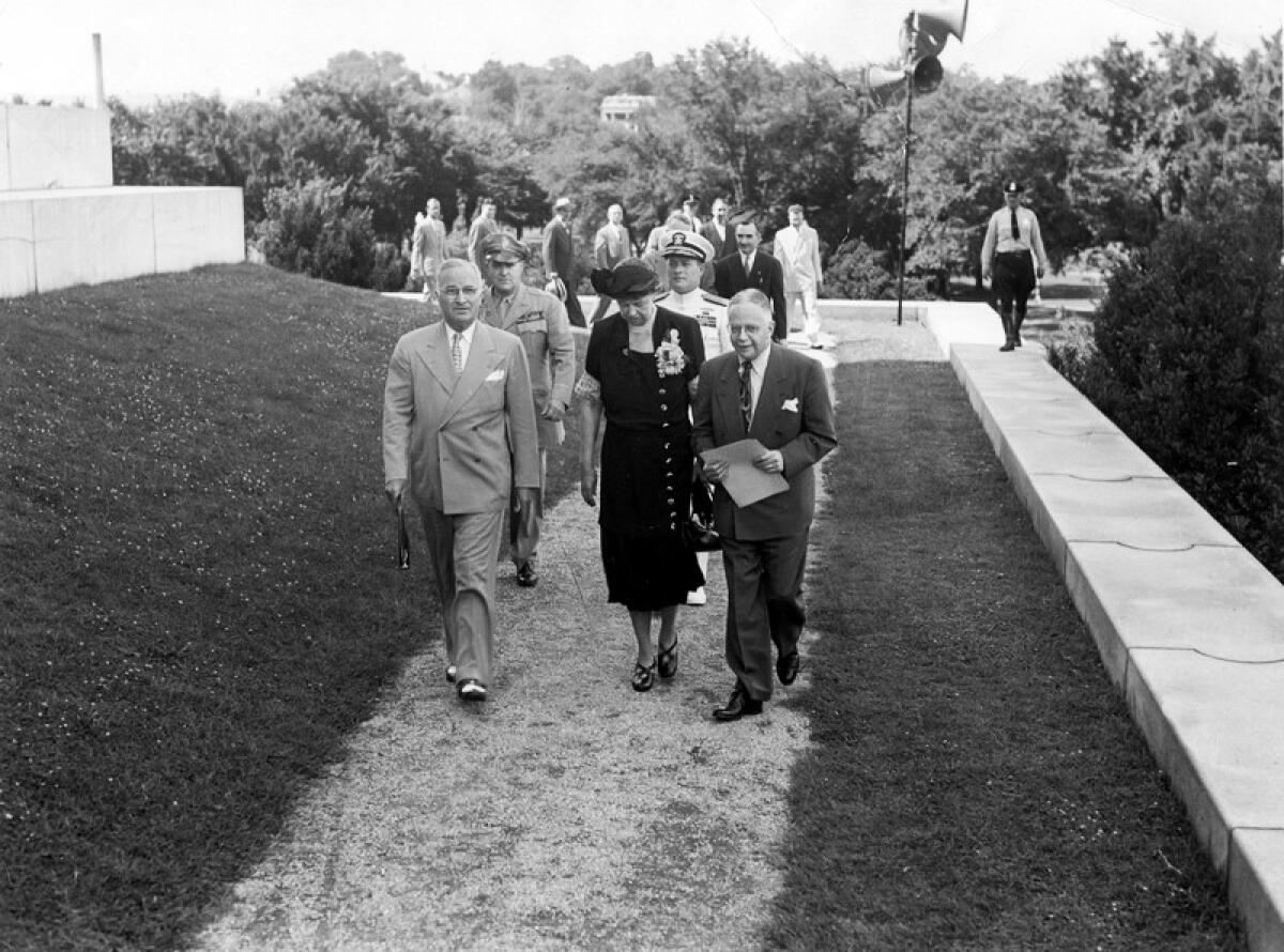 Walter White walks with President Truman and Eleanor Roosevelt.