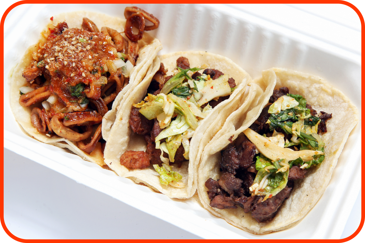 A mixed plate of tacos including one with calamari, pork, and short rib, left to right, at Kogi BBQ.